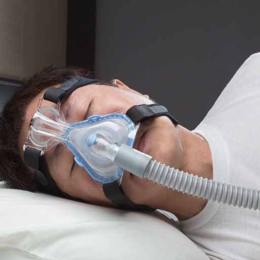 Dental patient sleeping with sleep apnea therapy CPAP mask