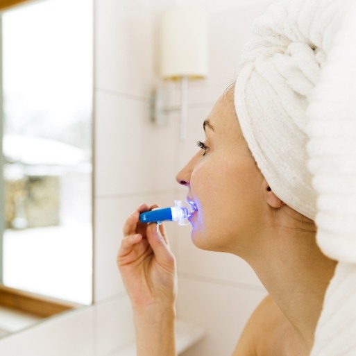 Dental patient using at home teeth whitening kit