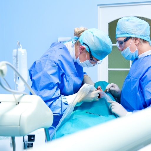 Dentist and team member treating dental patient