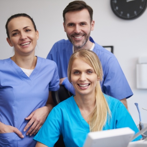 Three smiling dental team members