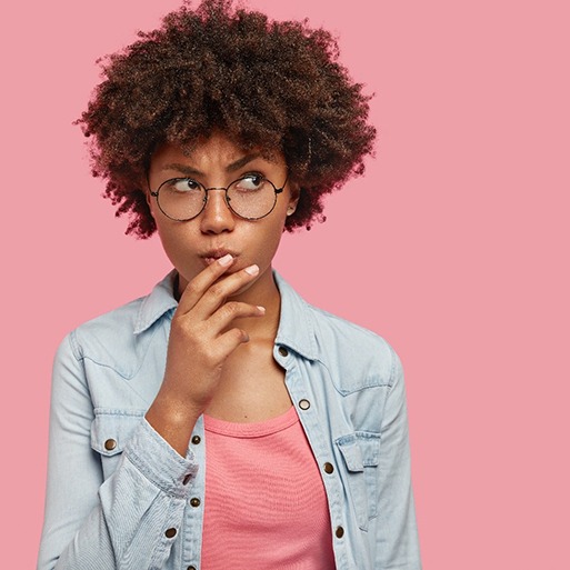 woman on pink background wondering about cosmetic dentistry in State College