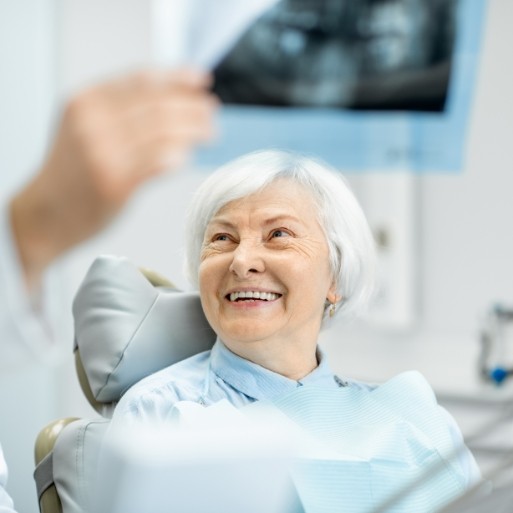 Woman smiling at dentist during six month dental checkup