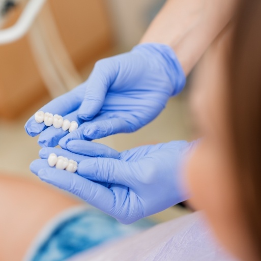 Dentist showing patient dental crown and bridge options