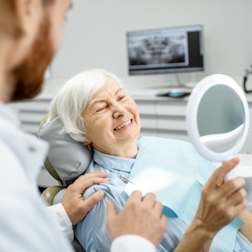 Dentist talking to dental patient about caring for dentures