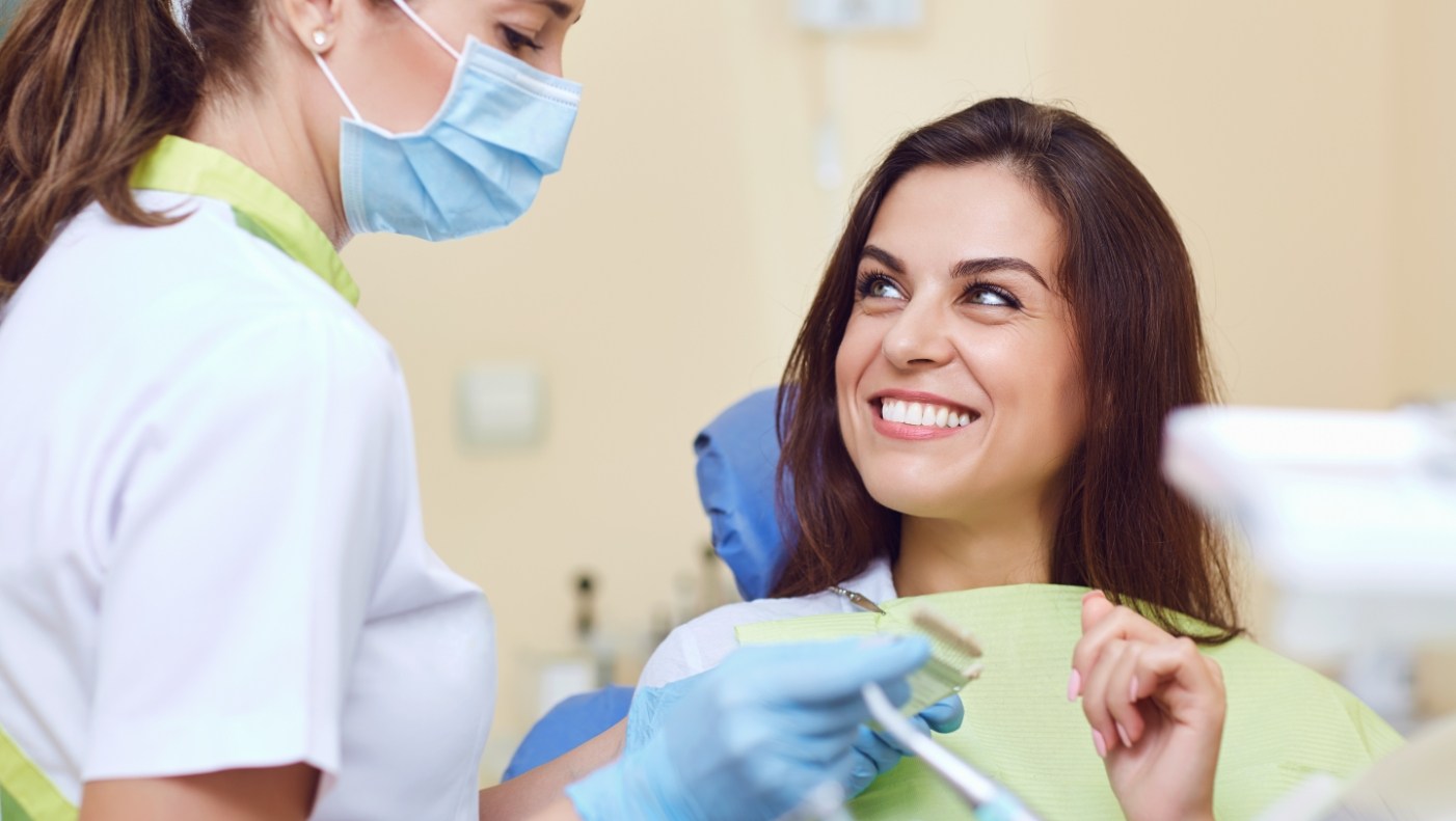 Woman discussing dental implants with dentist