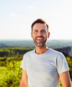 Man smiling after dental implant restorations