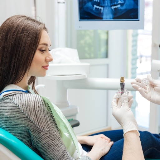Dentist and dental patient discussing the dental implant process
