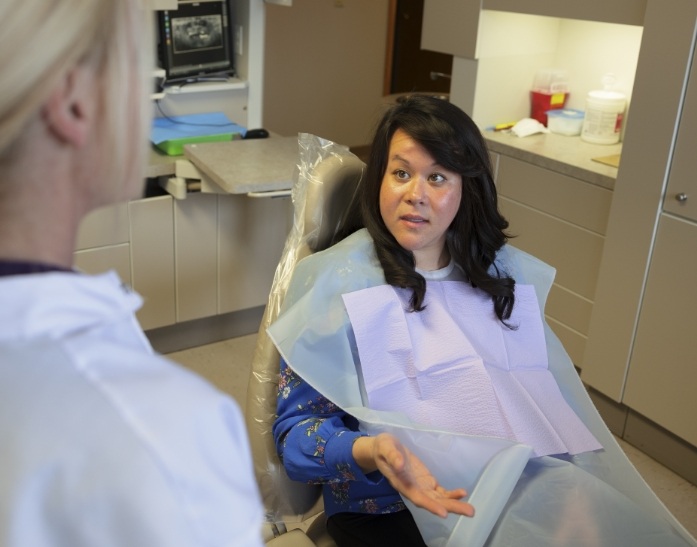 Dental patient talking to dental team member