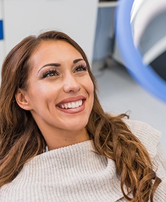 Woman smiling at reflection in mirror
