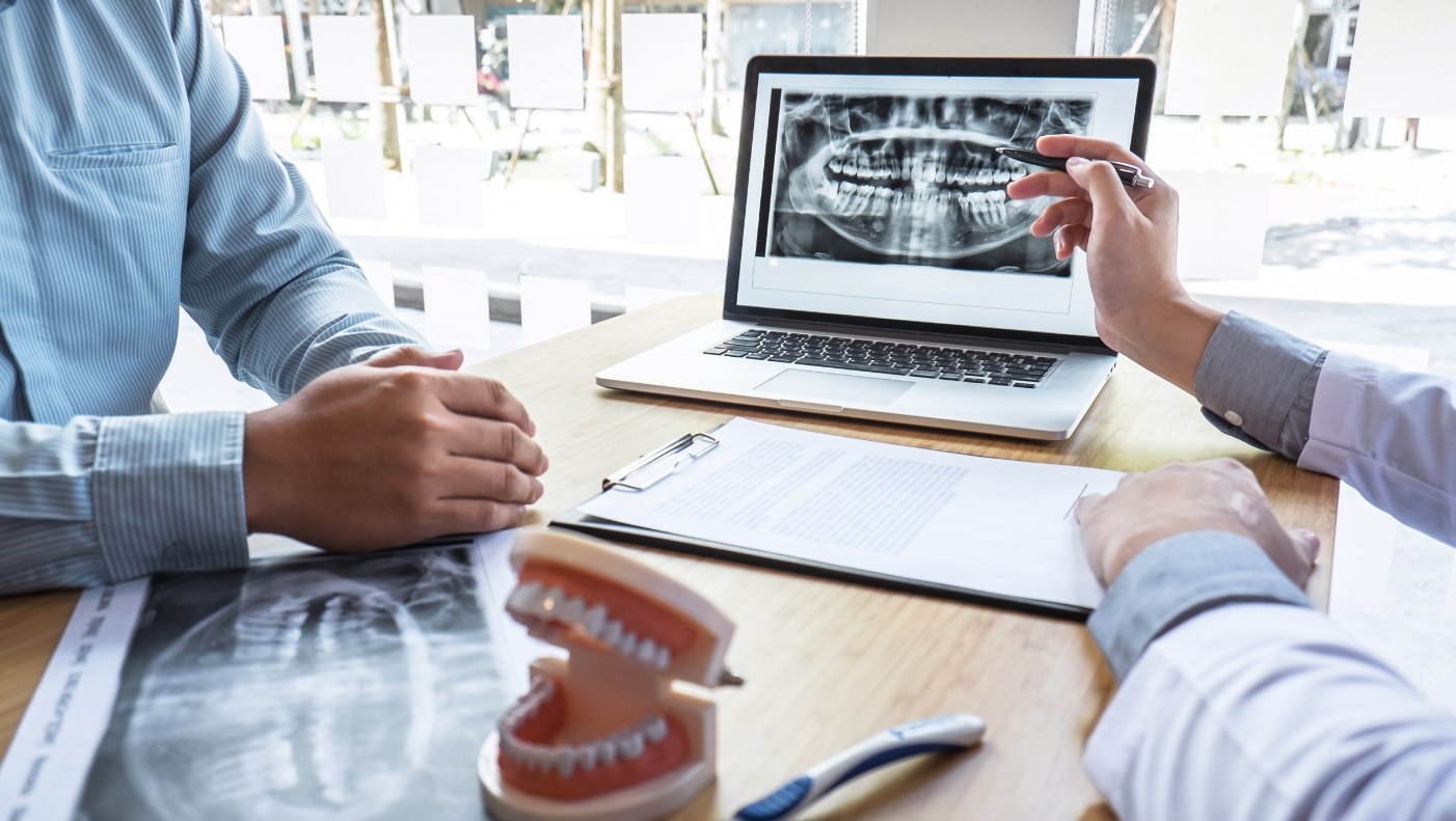 Dentist and patient discussing options for replacing missing teeth