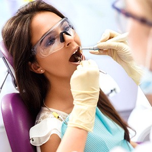 Woman having her teeth examined