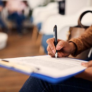 Person filling out paperwork