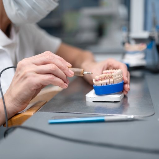 Dental lab technician crafting porcelain veneers