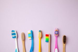 An array of toothbrush styles and colors on a light purple background