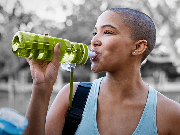 person drinking water to prevent winter mouth issues