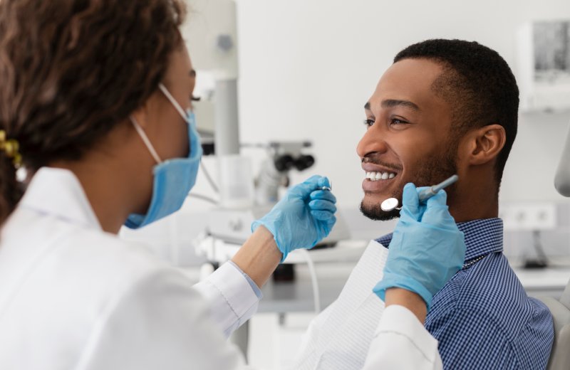 Patient smiling with their dentist after a dental checkup