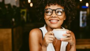 Woman drinking coffee during her treatment with clear aligners 